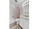 Bright bathroom featuring a shower-tub combo, decorative shower curtain, and a sink vanity with storage at 6328 E Mississippi Ave, Denver, CO 80224