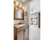 Bathroom with a modern vanity, with a view into an adjacent sunroom at 6328 E Mississippi Ave, Denver, CO 80224