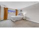 Spacious bedroom featuring a comfortable bed and large windows with ample light at 6328 E Mississippi Ave, Denver, CO 80224