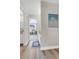 Bright hallway with wood floors and view into another room at 6328 E Mississippi Ave, Denver, CO 80224