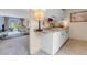 Partial view of a kitchen with white cabinets and a look into the living room at 6328 E Mississippi Ave, Denver, CO 80224