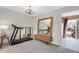 Bright living room featuring a treadmill and large mirror at 6328 E Mississippi Ave, Denver, CO 80224