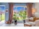 Bright living room features large windows with outdoor views, complemented by stylish furniture and decor at 6328 E Mississippi Ave, Denver, CO 80224