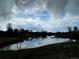 Beautiful pond reflecting cloudy sky, trees and landscape in the surrounding area at 6328 E Mississippi Ave, Denver, CO 80224