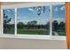 Picturesque window view of a green field and clear blue sky at 6328 E Mississippi Ave, Denver, CO 80224