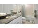 Bathroom featuring a granite vanity, and a shower-tub combo with tiled walls at 23721 E 40Th Ave, Aurora, CO 80019