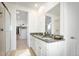 Well-lit bathroom with double vanity, granite countertop, and glass-enclosed shower at 23721 E 40Th Ave, Aurora, CO 80019