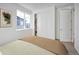 Bright bedroom with a cozy bed, closet, and a large window offering natural light at 23721 E 40Th Ave, Aurora, CO 80019