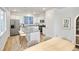 Bright, eat-in kitchen featuring white cabinets, stainless steel appliances, and stone countertops at 23721 E 40Th Ave, Aurora, CO 80019