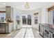 Sunny kitchen dining area with stainless dishwasher and sliding glass door to the backyard at 2490 S Jebel Way, Aurora, CO 80013