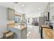 Sunlit kitchen with stainless steel appliances, wood counters, and light green cabinets at 2490 S Jebel Way, Aurora, CO 80013