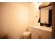 Updated half-bathroom featuring a modern vanity, gold fixtures, and stylish mirror at 1552 S Fairplay Way, Aurora, CO 80012