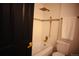 Newly renovated bathroom with modern fixtures, including a tiled shower-tub combination and gold hardware at 1552 S Fairplay Way, Aurora, CO 80012