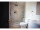 Modern bathroom featuring a spacious walk-in shower with marble-style tile and gold fixtures at 1552 S Fairplay Way, Aurora, CO 80012