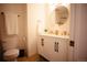Elegant bathroom featuring a double vanity, round mirror, and contemporary fixtures with plenty of natural light at 1552 S Fairplay Way, Aurora, CO 80012