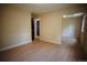 Neutral bedroom with mirrored closet, wood-look floors, and entry to another room at 1552 S Fairplay Way, Aurora, CO 80012