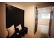 Entryway featuring a black bench with storage and a view to a light-filled room at 1552 S Fairplay Way, Aurora, CO 80012
