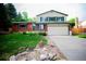 Charming two-story home featuring a brick facade, attached two-car garage, and a well-maintained front yard at 1552 S Fairplay Way, Aurora, CO 80012