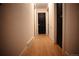 Clean hallway with modern flooring and dark doors, providing access to the various rooms in the home at 1552 S Fairplay Way, Aurora, CO 80012
