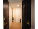 Hallway featuring wood-look floors and modern black doors with gold hardware at 1552 S Fairplay Way, Aurora, CO 80012
