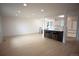 Bright, open-concept space with modern lighting, sleek floors, and a stylish kitchen with breakfast bar at 1552 S Fairplay Way, Aurora, CO 80012
