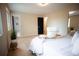 Bright primary bedroom showcasing neutral tones, natural light, and access to an en-suite bathroom for convenience at 1552 S Fairplay Way, Aurora, CO 80012