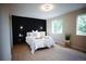 Serene primary bedroom featuring a stylish accent wall, ample natural light, and sleek modern decor at 1552 S Fairplay Way, Aurora, CO 80012