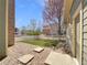 Landscaped backyard area featuring artificial turf, decorative rock, and paving stones, surrounded by a white picket fence at 2245 Whistler Dr, Longmont, CO 80504