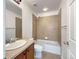 Bathroom with a tiled shower/tub and a wooden vanity with a sink at 2245 Whistler Dr, Longmont, CO 80504