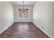 Dining room features tile floor, chandelier, and a large window at 2245 Whistler Dr, Longmont, CO 80504