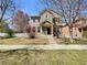 Charming two-story home with a combination brick and green siding exterior and a well-manicured lawn at 2245 Whistler Dr, Longmont, CO 80504