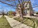 Green and brick two-story home with a sidewalk and tree-lined street at 2245 Whistler Dr, Longmont, CO 80504