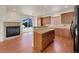 Open kitchen featuring granite countertops, wooden cabinets, and modern appliances at 2245 Whistler Dr, Longmont, CO 80504