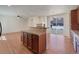 Open-concept kitchen island with granite countertops, adjacent living room with a fireplace and lots of light at 2245 Whistler Dr, Longmont, CO 80504