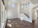 Bright living room featuring tile floors, a staircase, and high ceilings at 2245 Whistler Dr, Longmont, CO 80504