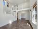 Bright, open-concept living room featuring soaring ceilings, a staircase, tile floors, and natural light at 2245 Whistler Dr, Longmont, CO 80504