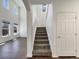 Carpeted staircase leading to the second floor with a view of the living room at 2245 Whistler Dr, Longmont, CO 80504
