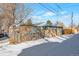 View of backyard with storage shed and chain link fence in winter at 950 S Leyden St, Denver, CO 80224
