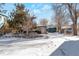 Rear view of house with snow covered yard at 950 S Leyden St, Denver, CO 80224