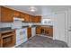 Cozy kitchen featuring wood cabinets, white appliances, and gray countertops at 950 S Leyden St, Denver, CO 80224