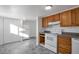 Bright kitchen with wood cabinets, white appliances, and gray countertops at 950 S Leyden St, Denver, CO 80224