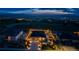 Aerial twilight view of a home with professional lighting, landscaping, and mountain views at 4213 Hickory Oaks St, Castle Rock, CO 80104