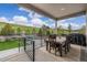 Covered back patio with an outdoor dining set and a lush green hillside view at 4213 Hickory Oaks St, Castle Rock, CO 80104