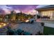 Backyard patio with a stone firepit, water feature, mature trees, professional landscaping, and comfortable seating at 4213 Hickory Oaks St, Castle Rock, CO 80104