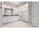 This bathroom is equipped with a double vanity, walk-in shower, and white-tiled floors at 4213 Hickory Oaks St, Castle Rock, CO 80104