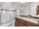 A bathroom featuring tiled shower with glass door, wood cabinets, and a toilet at 4213 Hickory Oaks St, Castle Rock, CO 80104