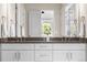 Bathroom's double vanity is complemented by a large window overlooking lush greenery at 4213 Hickory Oaks St, Castle Rock, CO 80104