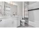 A tiled bathroom with white cabinets, contrasting floor tiles, and stylish shower at 4213 Hickory Oaks St, Castle Rock, CO 80104
