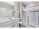 Bright bathroom with a quartz countertop vanity, glass-enclosed shower, and contemporary finishes at 4213 Hickory Oaks St, Castle Rock, CO 80104