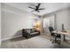 Bedroom with a sofa, ceiling fan, and a dedicated workspace area, offering comfort and functionality at 4213 Hickory Oaks St, Castle Rock, CO 80104